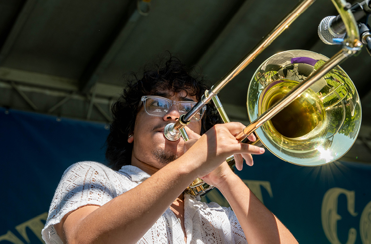 A student performs on the trombone on stage