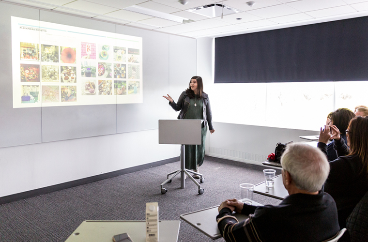 a design management student presents in front of a room