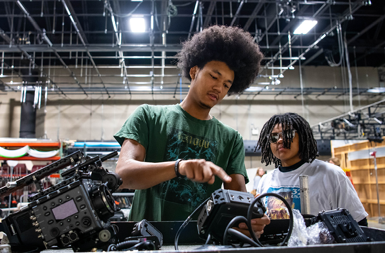 two students assembling a movie camera