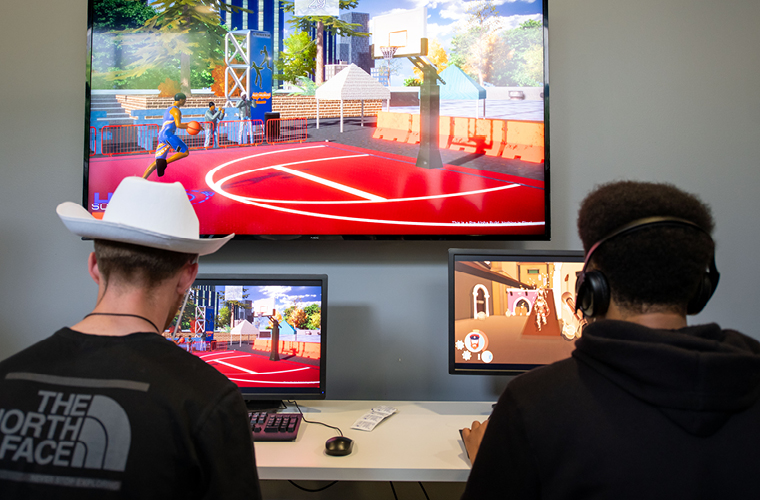 Two Immersive Media students working on computers