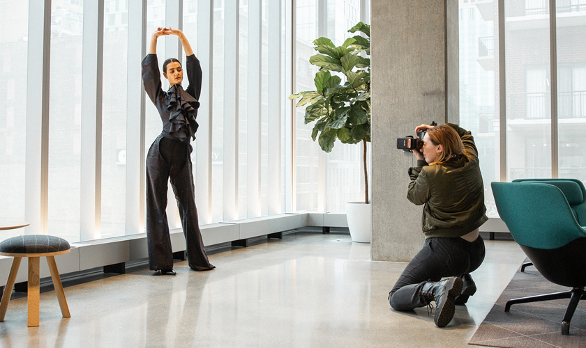 a photographer works with a model in the student center