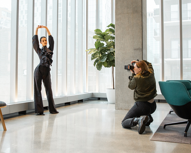 a photographer works with a model in the student center