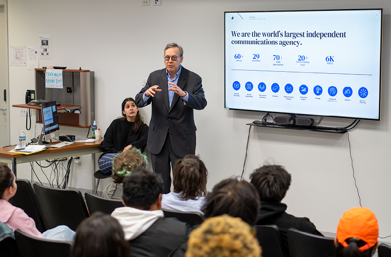 a public relations professional presents to a classroom of students