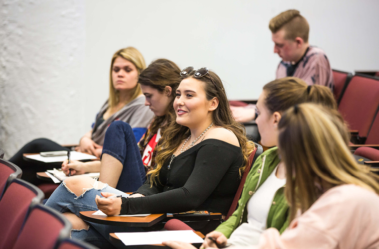 students sit in a row of seats in a social media course