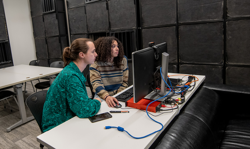 two sounds design students work together on a computer