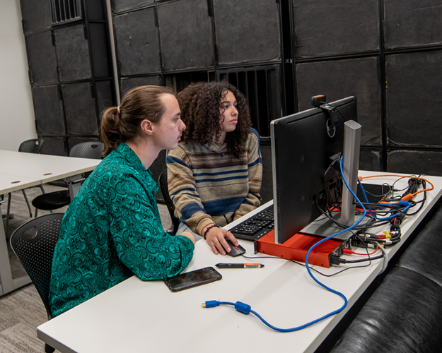 two sounds design students work together on a computer