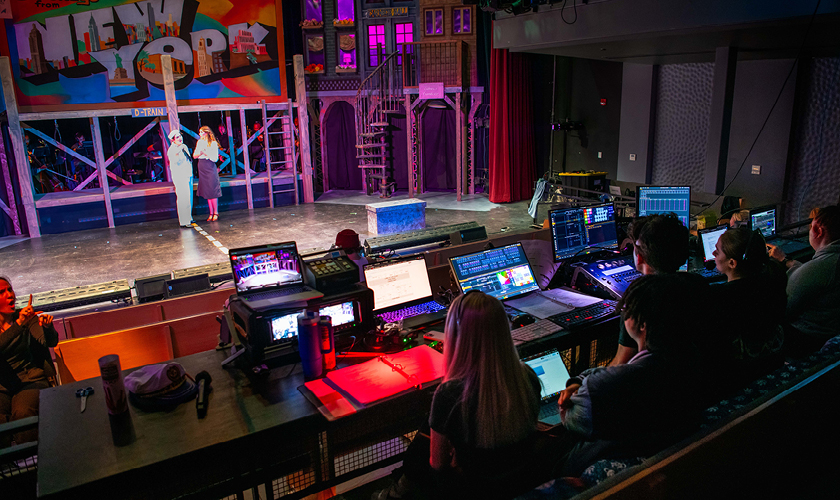 theater stage set with computers and sound board control equipment