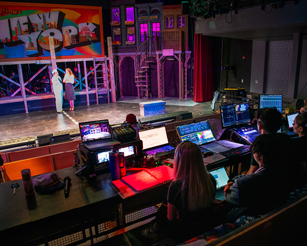 theater stage set with computers and sound board control equipment