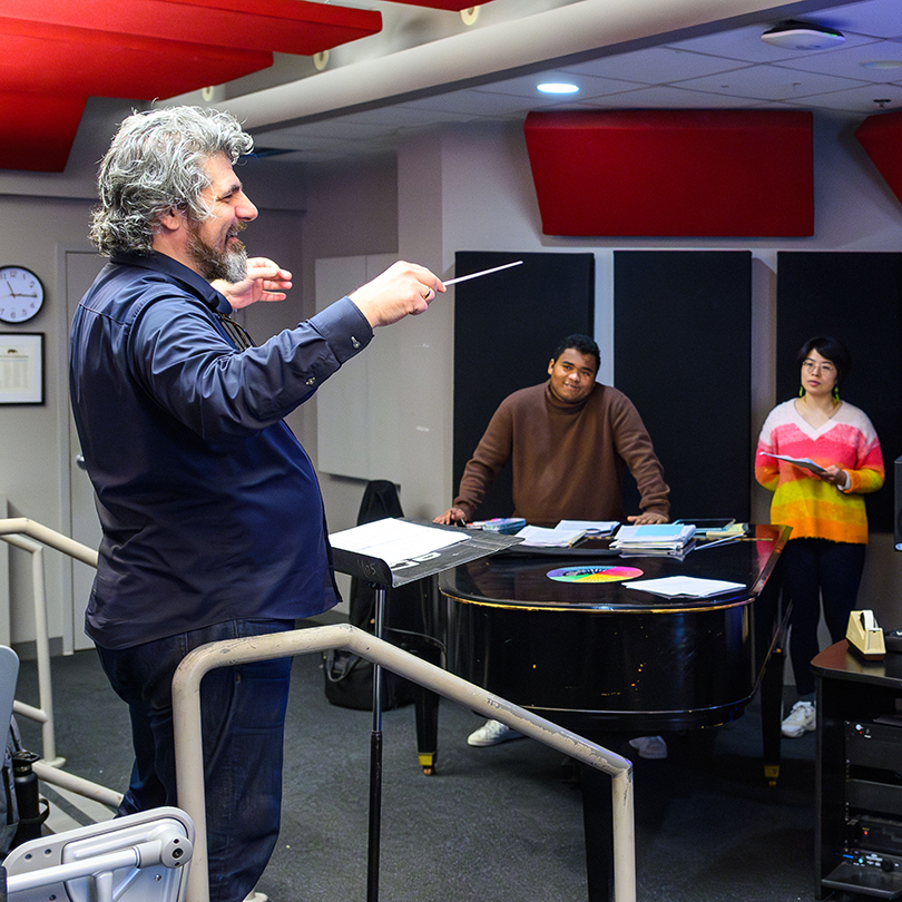 professor conducting student musicians