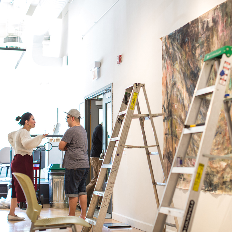 students setting up art installation in gallery