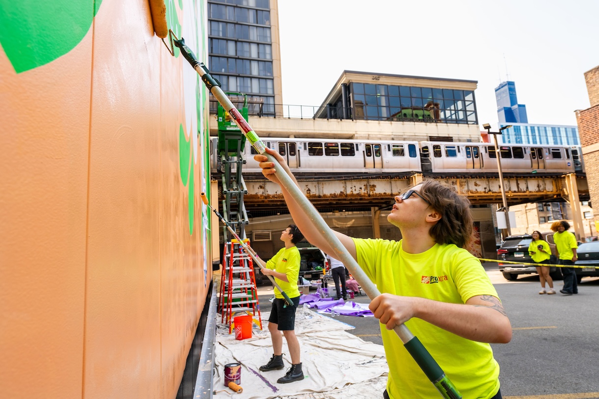 Students working on the "Curious Bunny" mural on the Student Center.