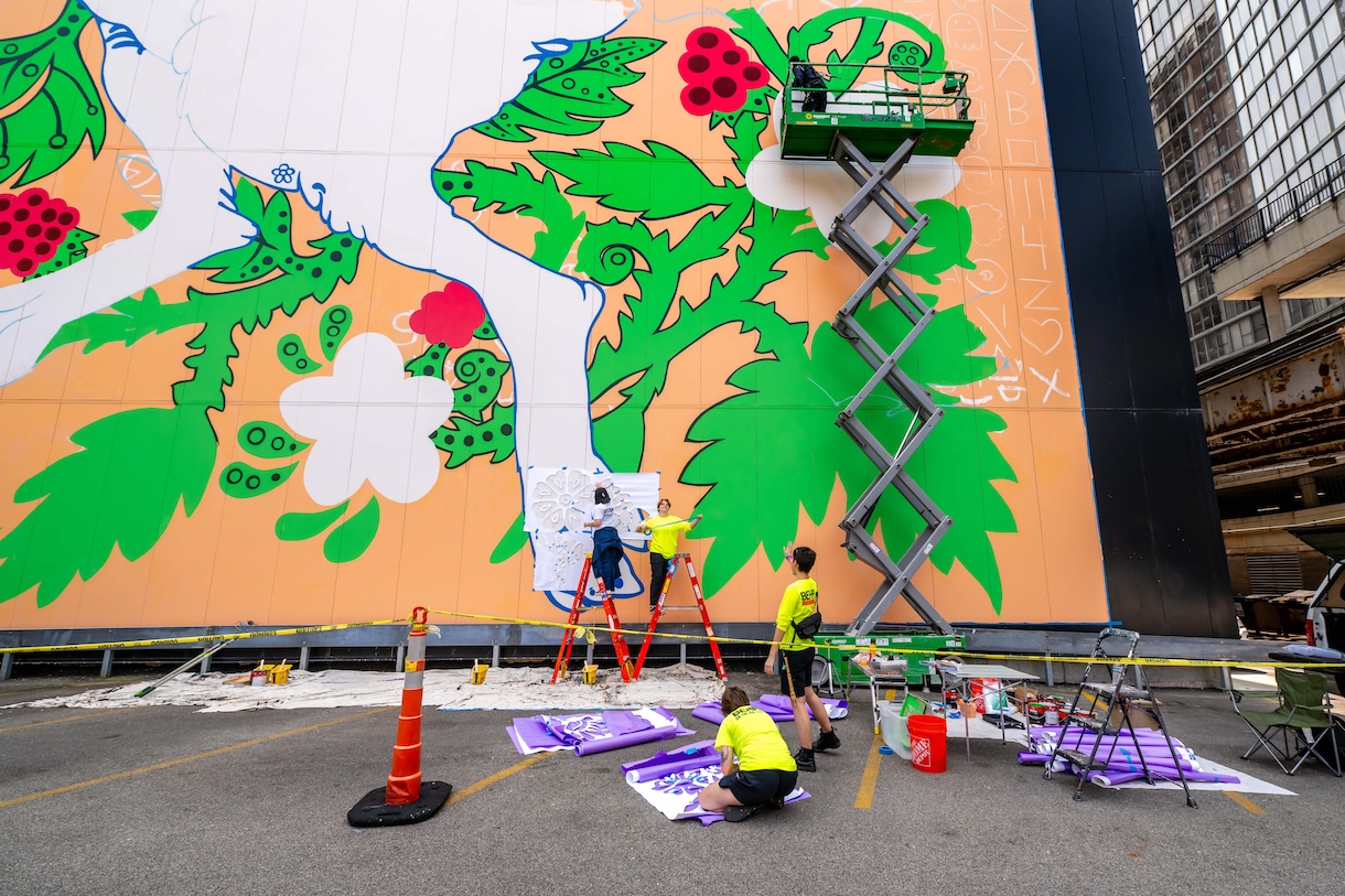 Students working on the "Curious Bunny" mural on the Student Center.