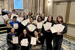 group of students posing with their award certificates