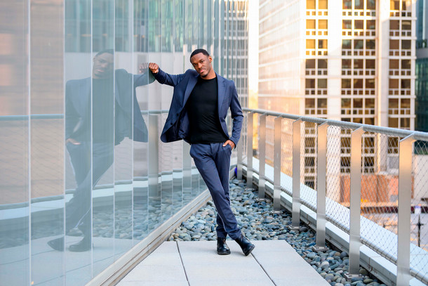 Columbia senior Eli Dennard leans against the wall of the Student Center while posing for a photo.