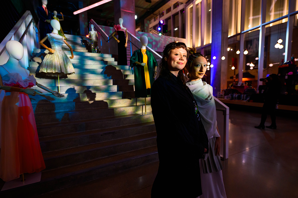 fashion models on staircase with two individuals in foreground