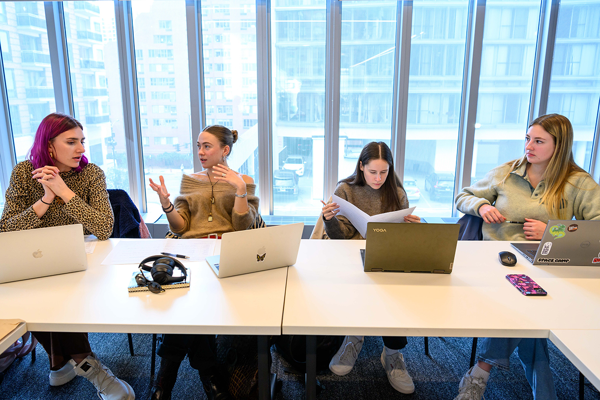 students conferring at conference table