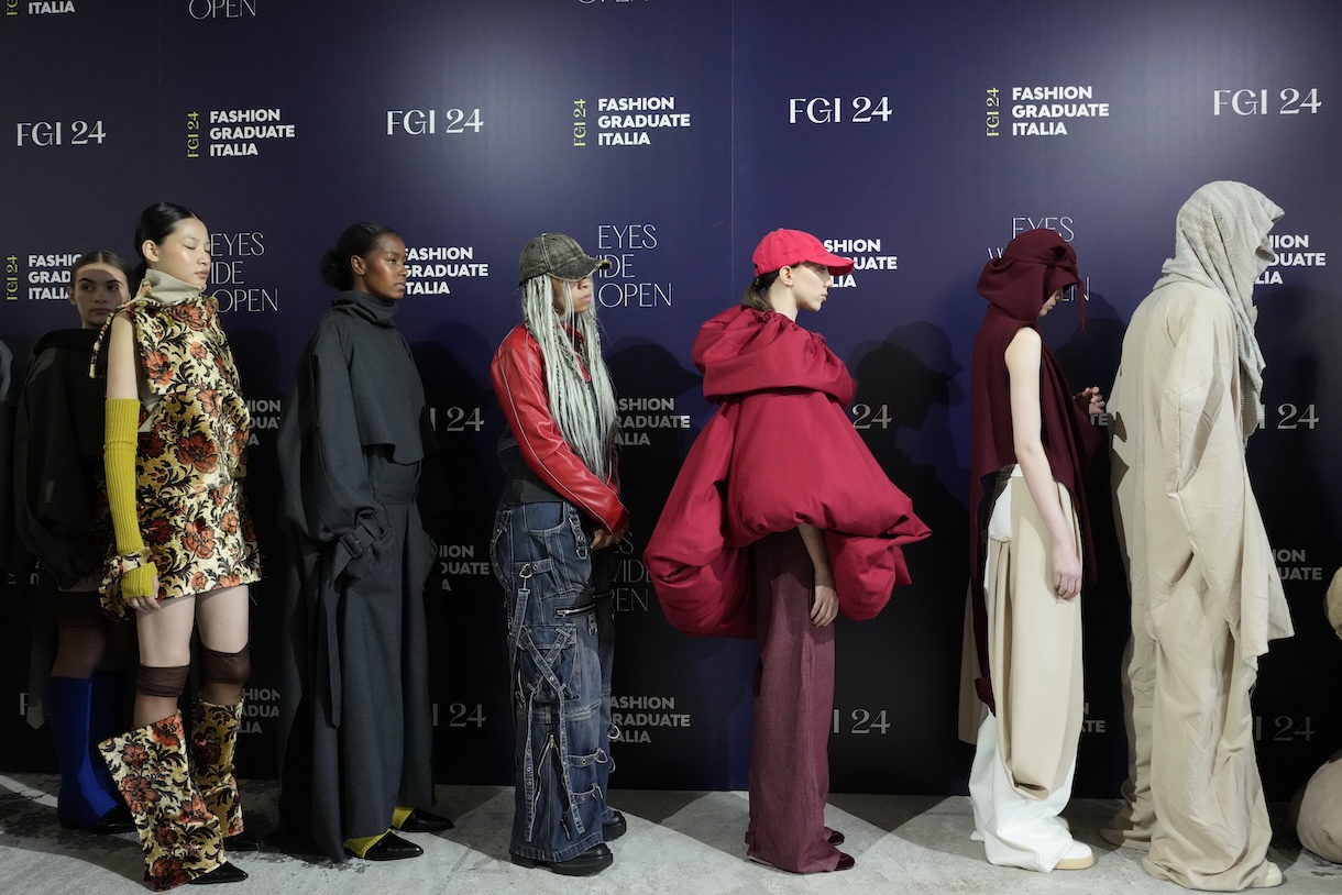 Student designer Joelle Olabode (third from left,) waits in line behind three models wearing her designs prior to appearing on thecrunway during the City to City show of the Fashion Graduate Italia 2024 event. Photo by Daniele Schiavello