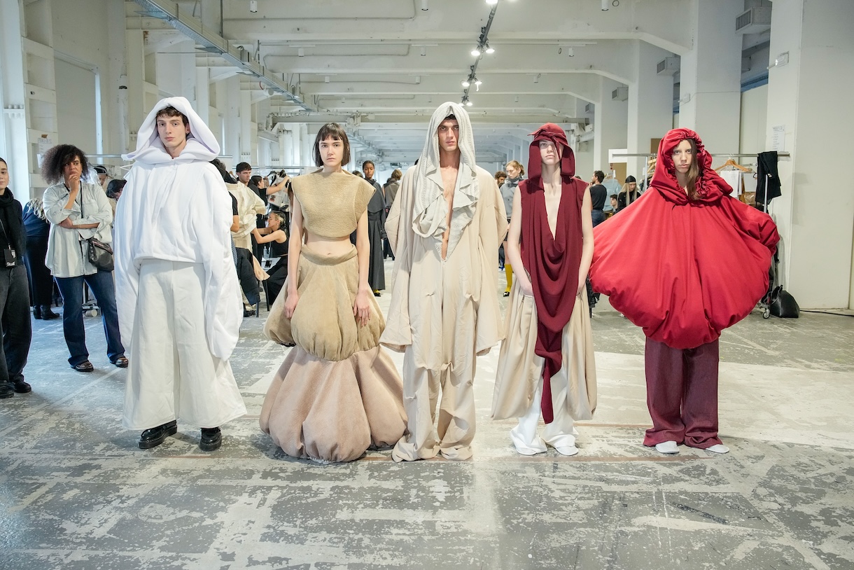 Five models appear in a fittings lineup wearing the “Adams” collection by Joelle Helena Olabode. Photo by Gianluca Carraro