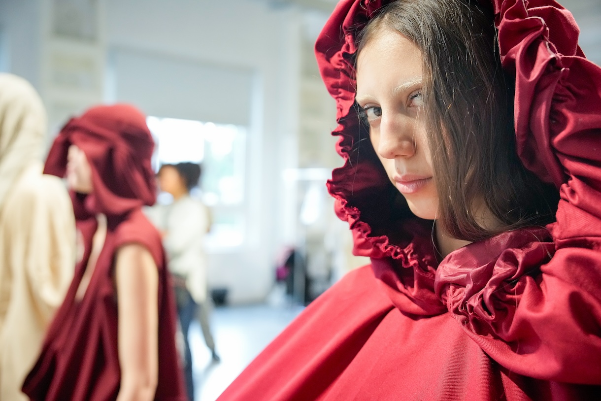 A model wears a red ruffled ensemble by Joelle Helena Olabode during the fittings session of the Fashion Graduate Italia 2024 Talent to Talent runway. Photo by Gianluca Carraro