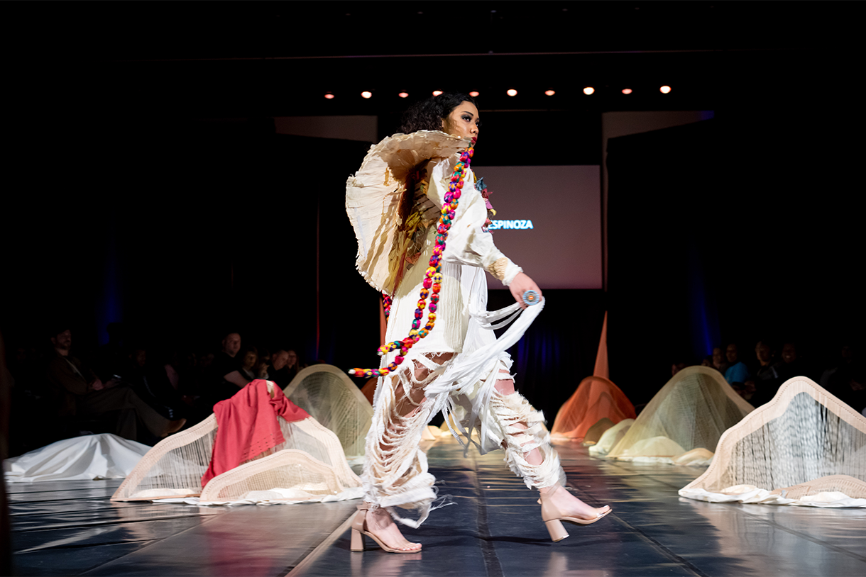 model on stage wearing clothes inspired by designer's heritage
