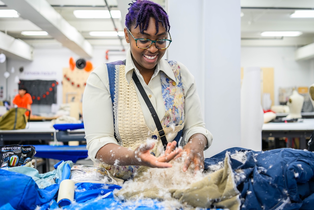 A student works on their design using upcycled Patagonia materials.