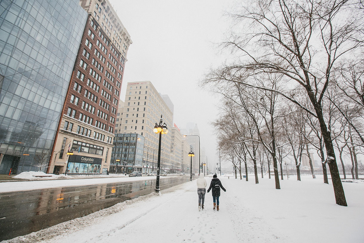 two people walking on chicago's michigan avenue in snow