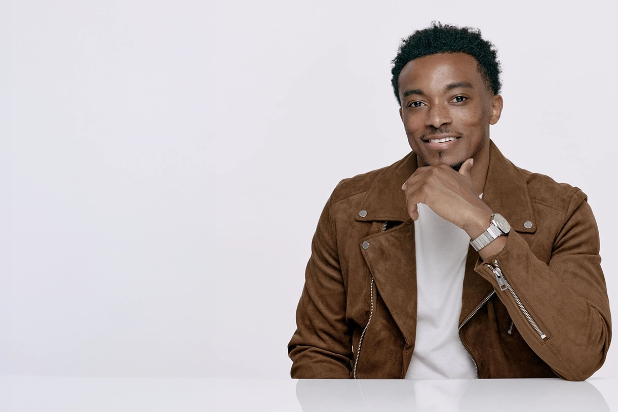 portrait image of jonathan mcreynolds sitting with hand on chin