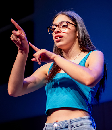 Student using American Sign Language at an event