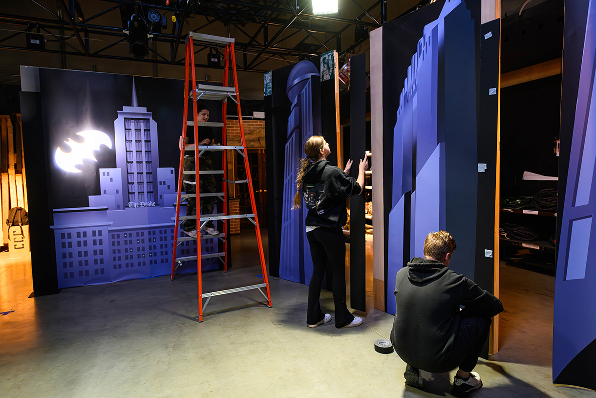 sound state with graphics of buildings and bat signal, with students installing graphics